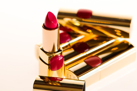 Red and pink lipsticks in white isolated backgroundの写真素材