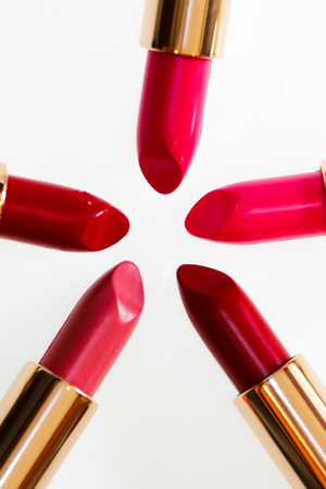 Red and pink lipsticks in white isolated backgroundの写真素材