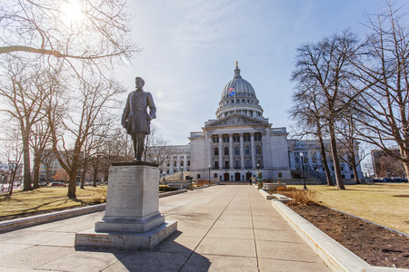 Statue of Hans Christian Heg in front of Wisconsin state capitol building in Madison Wisconsin on a sunny day with sun shining through the treesのeditorial素材