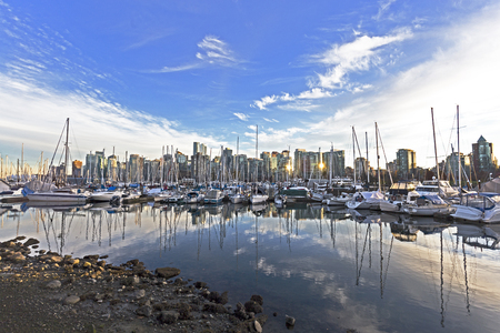 Vancouver, BC harbor and boats at sunset, with city skyline in the backgroundの写真素材
