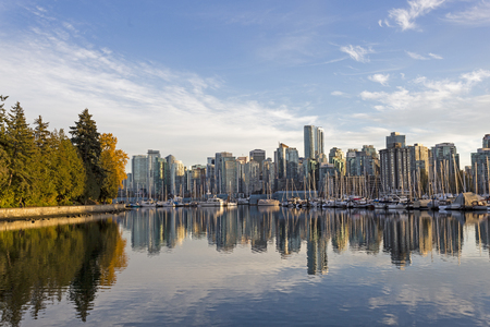 Skyline of Vancouver, British Columbia, with harbor and boats at sunsetの写真素材