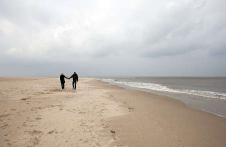 Couple is walking on the beachの写真素材