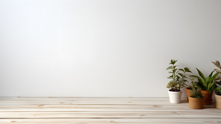 Wooden floor with green plants and white wall in the background.の素材