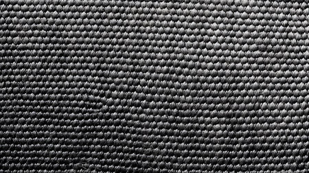 Close-up of a textured black and white fabric background.の素材