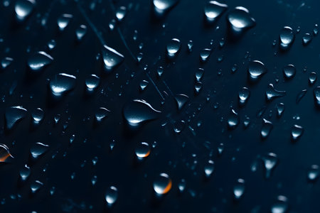 Water drops on a dark blue background. Shallow depth of field.の素材