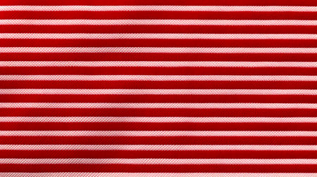 Red and white striped fabric as a background texture. Close-up.の素材