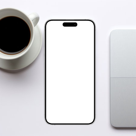 Smartphone with blank screen and coffee cup on white background, top viewの素材