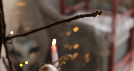 Blurred background with candle flickers gently, providing warm light filled with soft textures and glowing fairy lights, creating an inviting ambiance perfect for relaxation.の写真素材