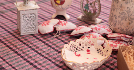 Decorating Easter eggs and coloring activities come to life on a warm table filled with unique crafts. A variety of soft, handmade items and decorative pieces enhance the festive atmosphere.の写真素材
