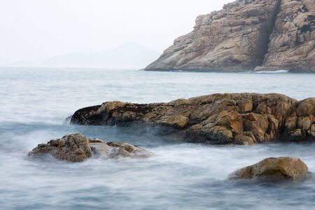 Long exposure of rock coast backgroundの写真素材