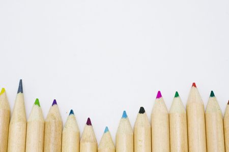 Colored pencils forming a color row. White background.の写真素材
