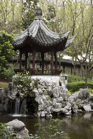 A typical Chinese garden with a pond.の写真素材