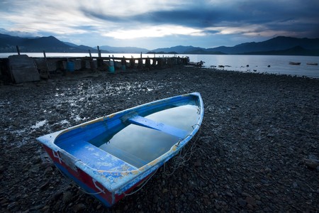 Old fish-boat on beach. の写真素材