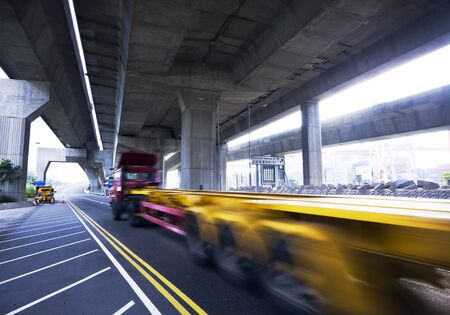 container car fast moving under the freeway bridgeの写真素材