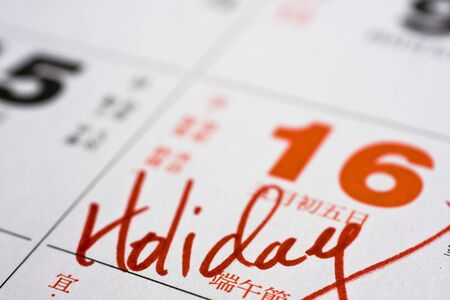 Hand writing holiday important date on calendarの写真素材