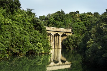 ancient roman bridge in the forest on the lakeの写真素材
