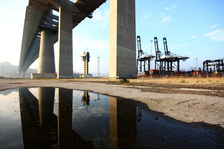 huge bridge near the container station at day