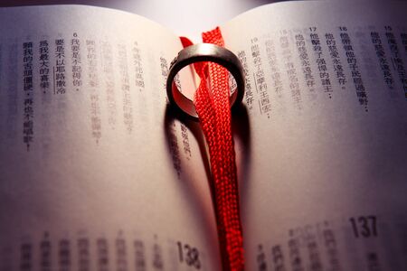 Wedding Ring on a chinese bible.の写真素材