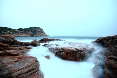 Sea stones at sunset in hong kong.の写真素材