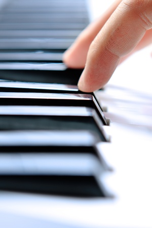Close up of the hands of a young man playing piano の写真素材