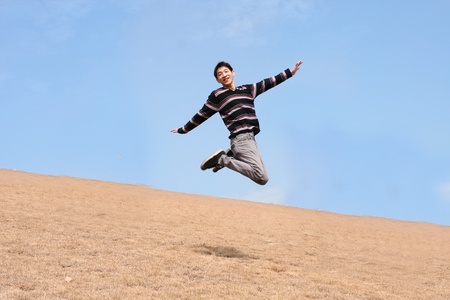 Happy jumping man on winter day の写真素材