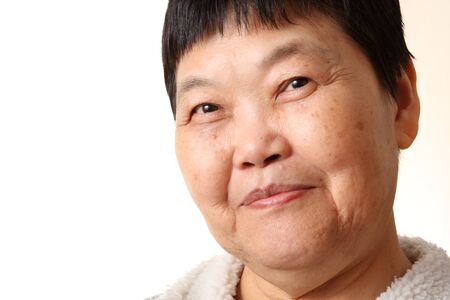 Studio Portrait Of Smiling Senior Woman の写真素材