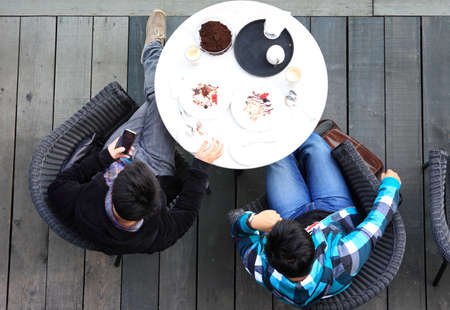 Aerial view of two man talking while having teaの写真素材