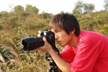 photographer taking photo in country side の写真素材