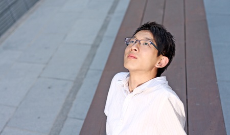 Young caucasian businessman sitting on benchの写真素材