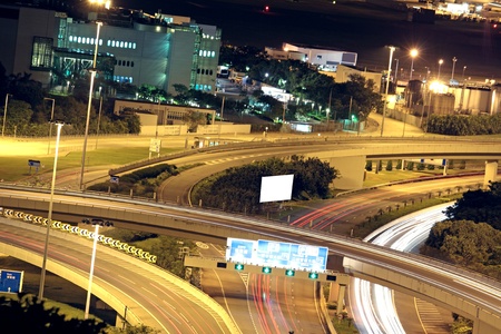 Freeway in night with cars light in modern city. 