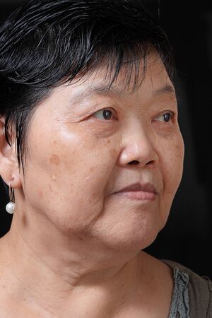 old woman on black background の写真素材