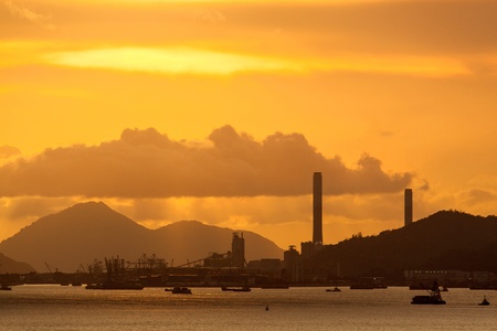 power plant with an intense red and cloudy evening sky の写真素材