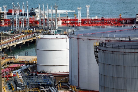 Oil tanks and ship at dayの写真素材