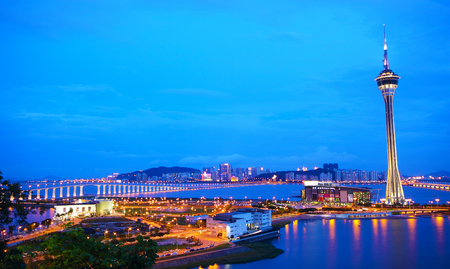 Urban landscape of Macau with famous traveling tower under blue sky near river in Macao, Asia. のeditorial素材