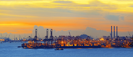 Silhouette of several cranes in a harbor, shot during sunset.のeditorial素材