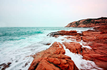 rocky sea coast and blurred water in shek o,hong kong の写真素材