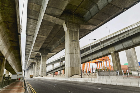 Empty asphalt road under the new expressway line at dayの写真素材