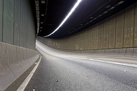 Interior of an urban tunnel without traffic in hong kong modern city at nightの写真素材
