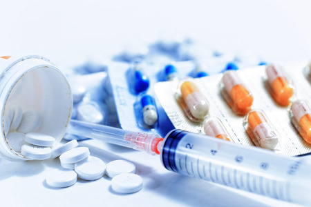 Syringe with glass vials and medications pills drug Syringe with glass vials and medications pills drug