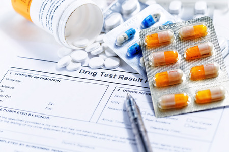 Syringe with glass vials and medications pills drug test reportの写真素材