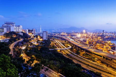 container terminal and stonecutter bridge in Hong Kong at sunsetの写真素材