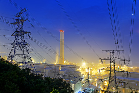 Power station with smoke at nightの写真素材