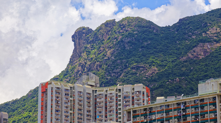 hong kong public estate with landmark lion rock at dayの写真素材