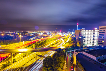 Long exposure shot of Auckland New Zealand transport at night with sky towerの写真素材
