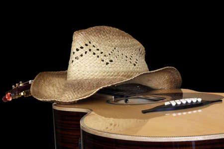 acoustic guitar with hat isolated on blackの写真素材