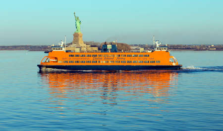 NEW YORK, USA, APRIL 19, 2015: Early morning sunlight reflecting off the Staten Island Ferry, a free ferry service between St. George on Staten Island and Whitehall Street in lower Manhattanのeditorial素材