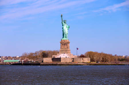 The Statue of Liberty lit by the early morning sunriseの写真素材