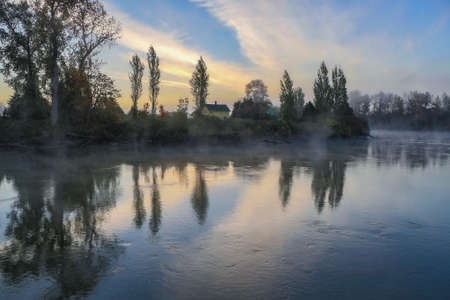 Early morning autumn mist rising off the Snohomish riverの写真素材