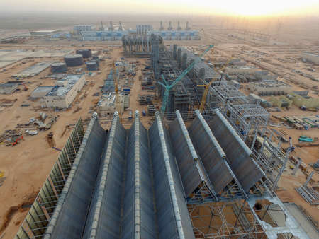 Aerial view of a large combined cycle power plant being constructed.