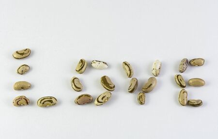 Love is written with Bean from the village Smolian in Bulgaria. the word is isolated on a white backgroundの写真素材